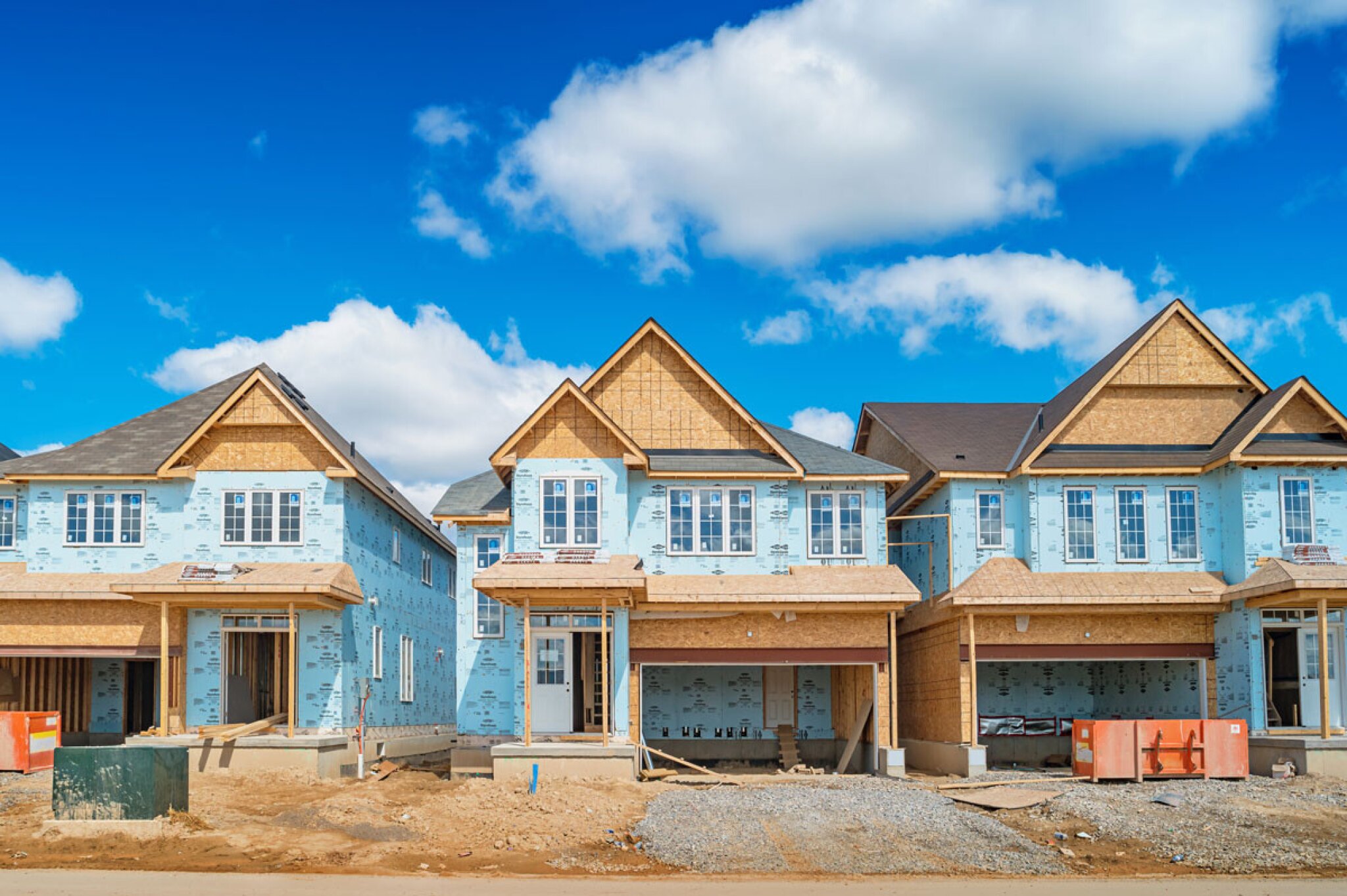 New house under construction with exposed framing and materials.