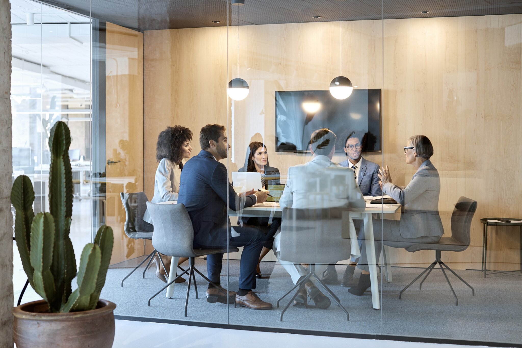 A group collaborates in a meeting room.