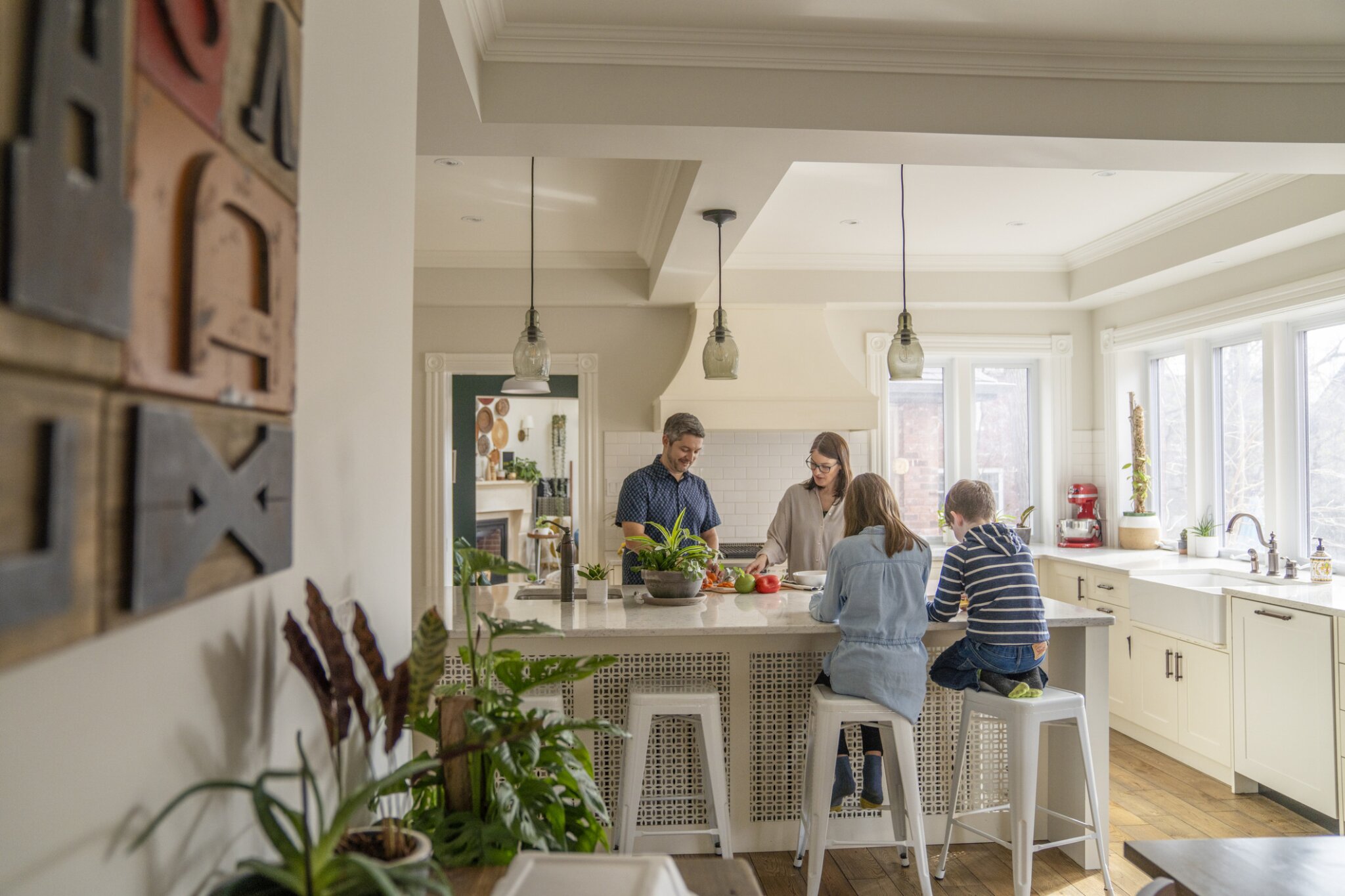 A family sits together at a kitchen island.
