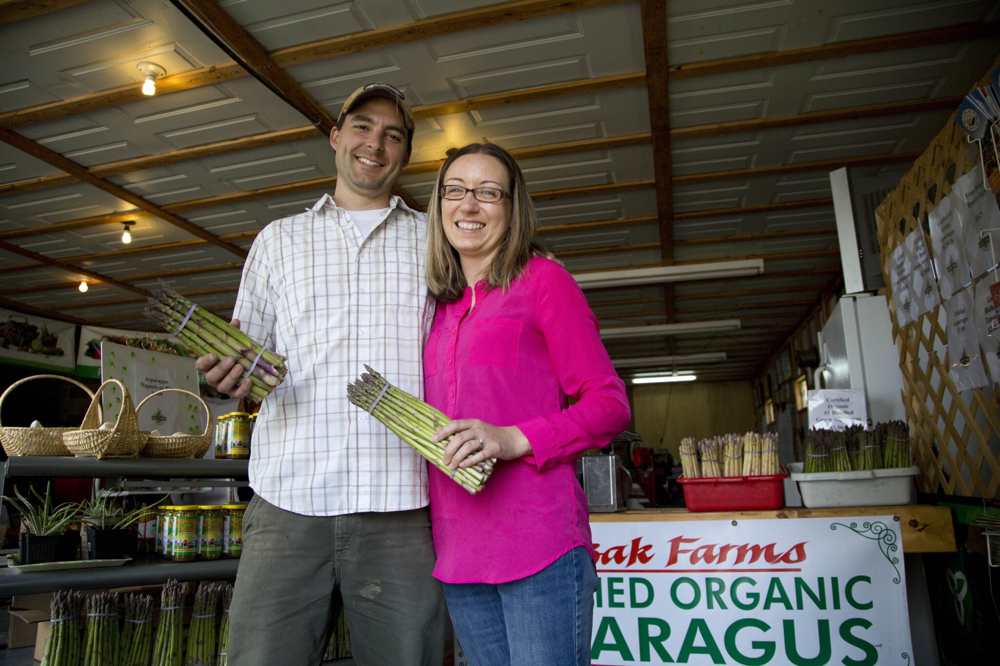 couple holding asparagus.